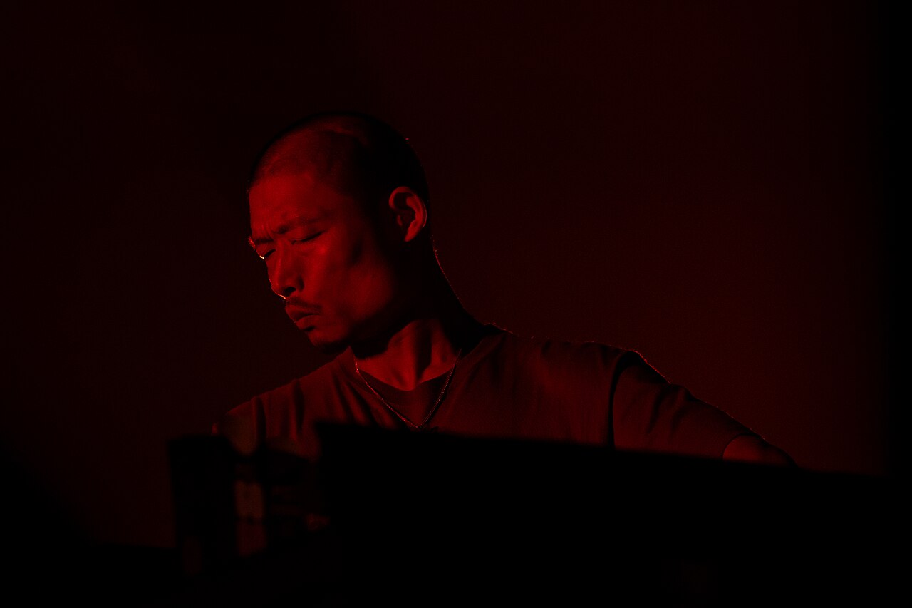 2026年のモントルー・ジャズ・フェスティバルで、サイズを絞った照明の下、ブースでプレイする Yousuke Yukimatsu